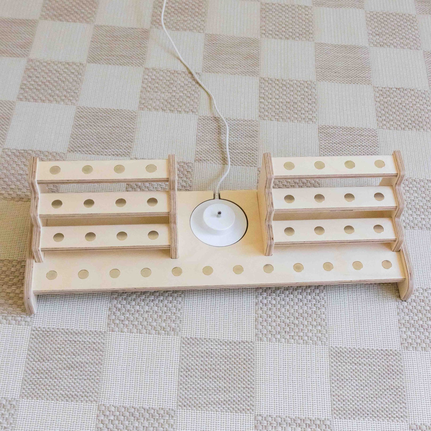 Tonie shelf made from wood featuring a cut out in the wood designed t hold the charger for the tiniebox.