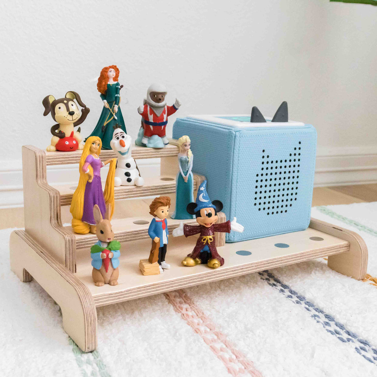 Toniebox display made from wood showing its ability to hold the toniebox and up to 15 tonie characters.