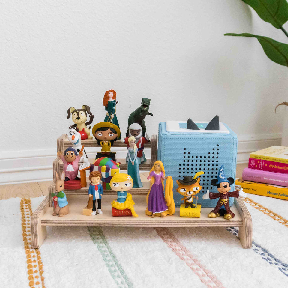 A display made from wood designed to hold a toniebox and tonies. The display is made from wood and is able to hold up to 15 Tinies and the toniebox.