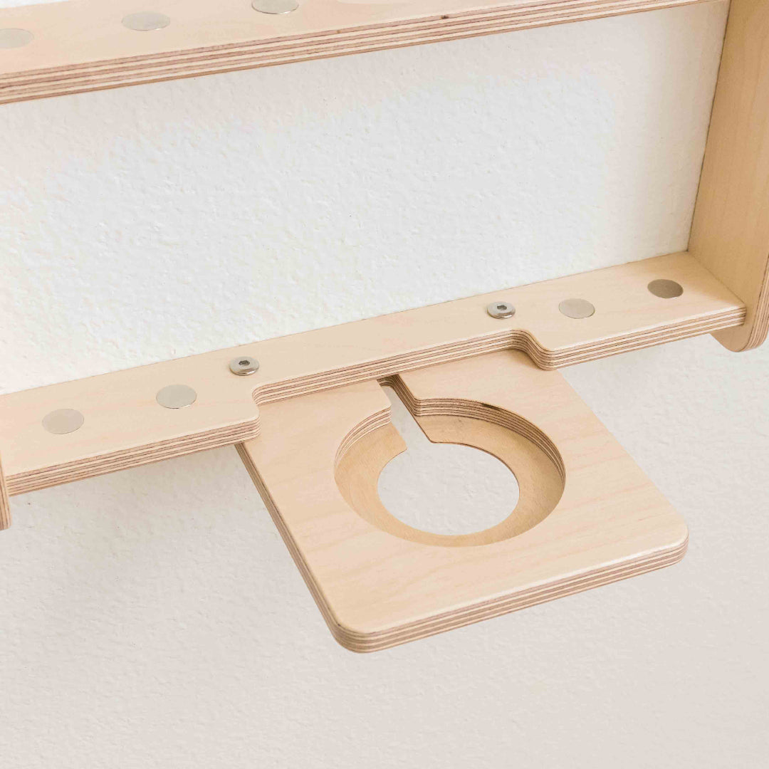 View of a tonie regal with built in slot for a charging cord and recessed metal dots to hold the tonie figures in place.