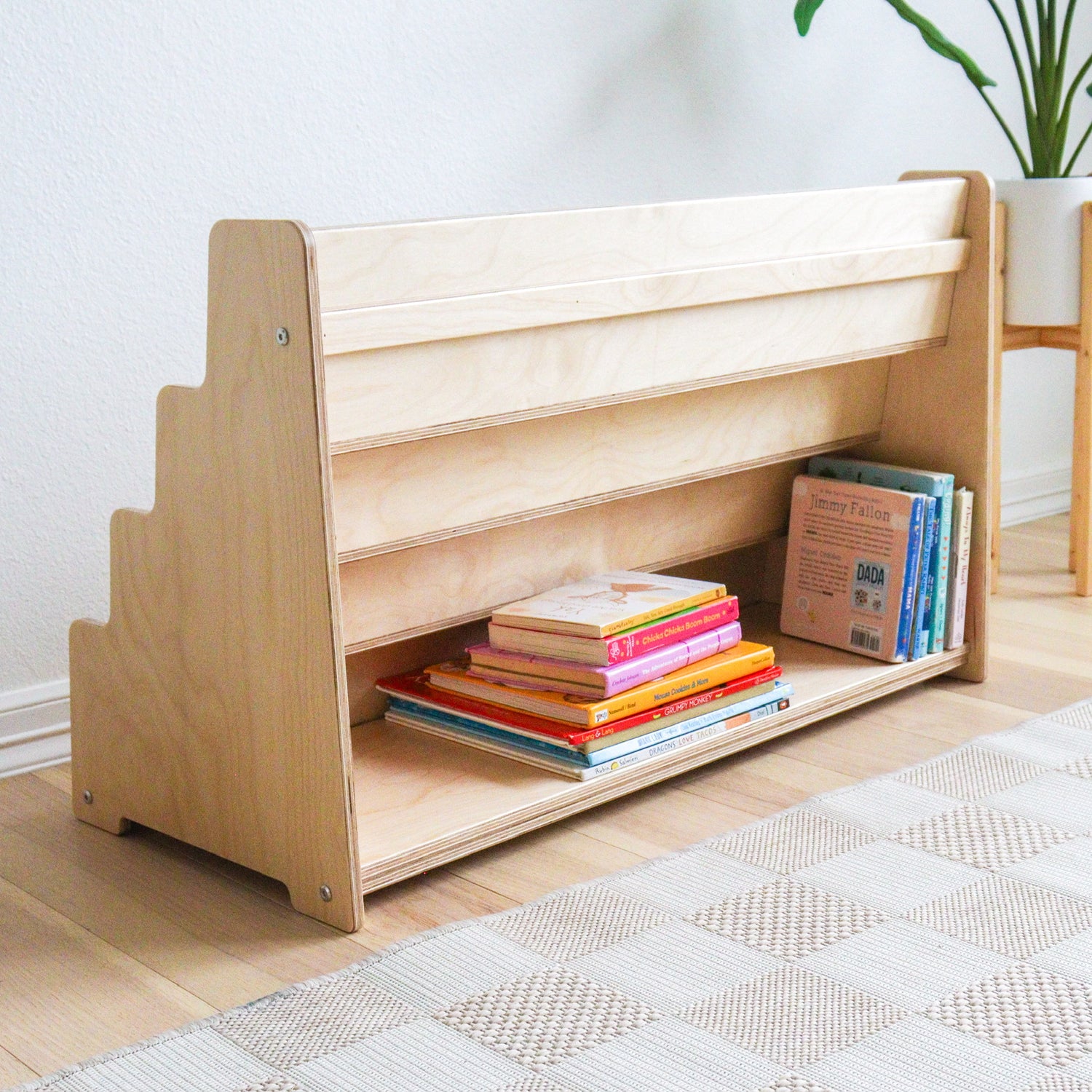 Montessori bookshelf showing the extra storage space on the back of the bookshelf. 