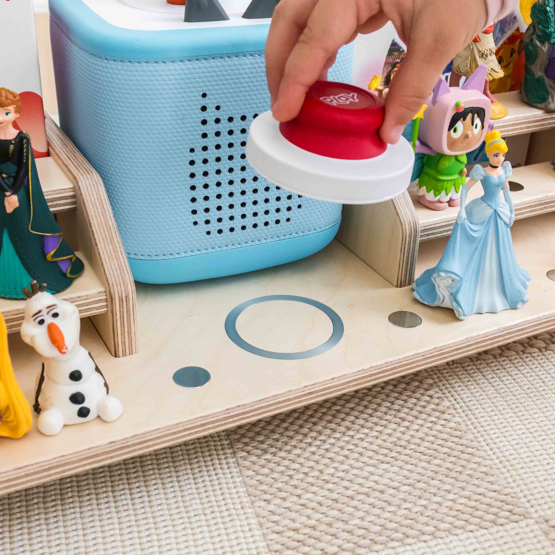 Tonieplay controller being placed on a display designed to hold the controller using magnets. 