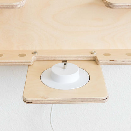 Toniebox charger resting into a cutout on a wall tonieshelf