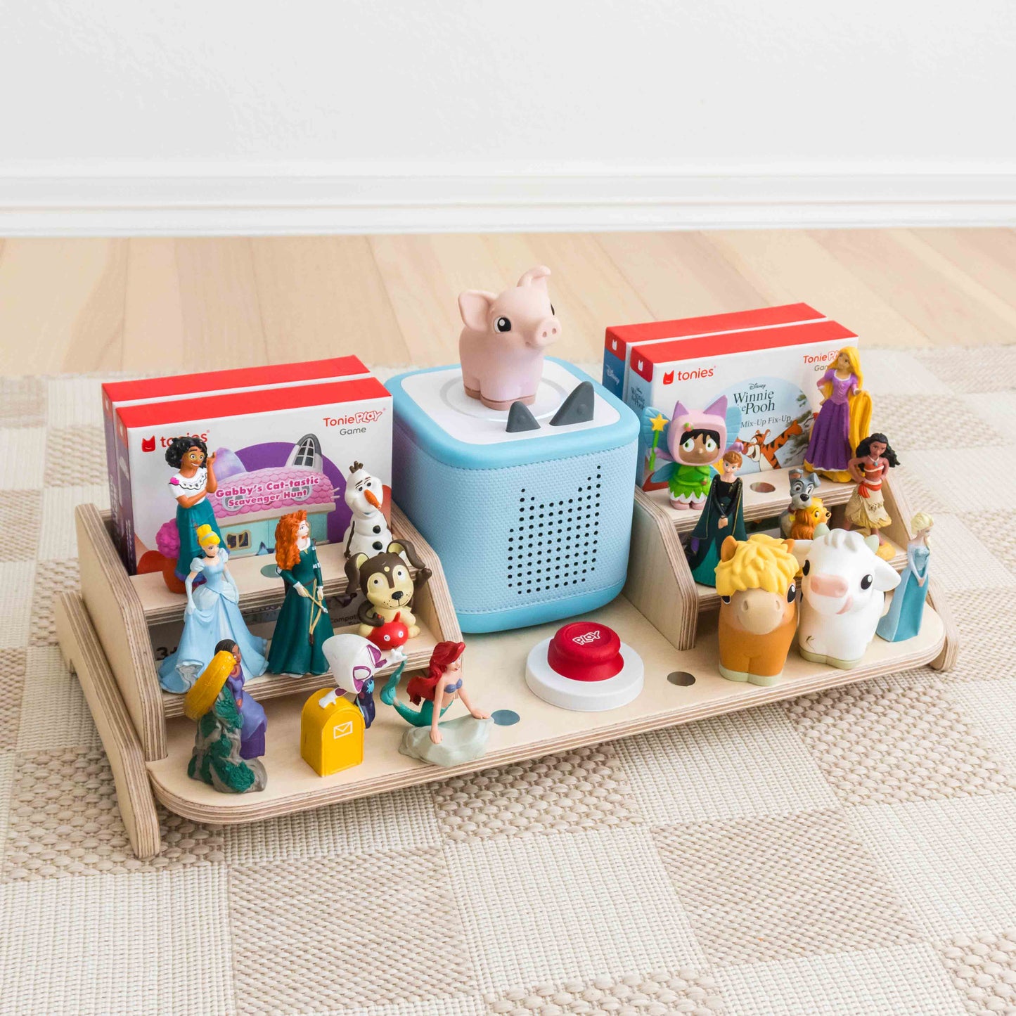 A wooden display designed to hold and display the toniebox 2, tonie figures, tonieplay controller, and tonieplay games. 
