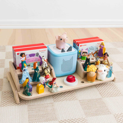 A wooden display designed to hold and display the toniebox 2, tonie figures, tonieplay controller, and tonieplay games. 
