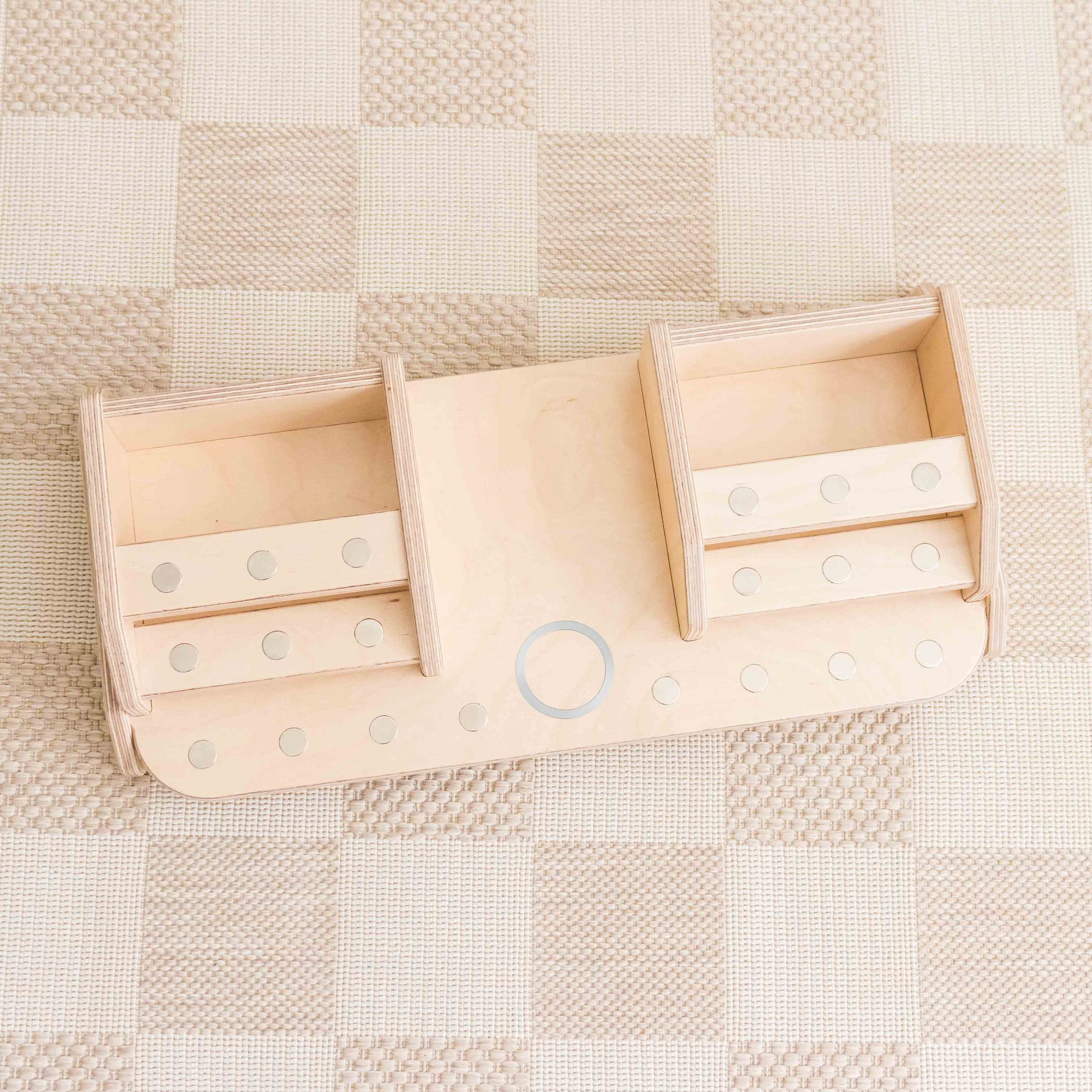 Wooden toniebo storage display with metal dots to hold tonies in place.