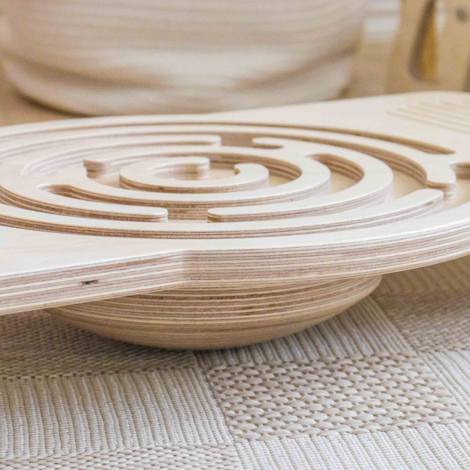 Wooden kids balance board puzzle on a textured surface